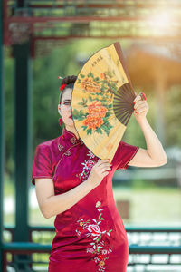 Midsection of woman holding umbrella