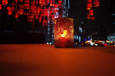 Close-up of illuminated lamp at night