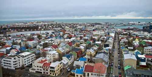 View of cityscape against cloudy sky