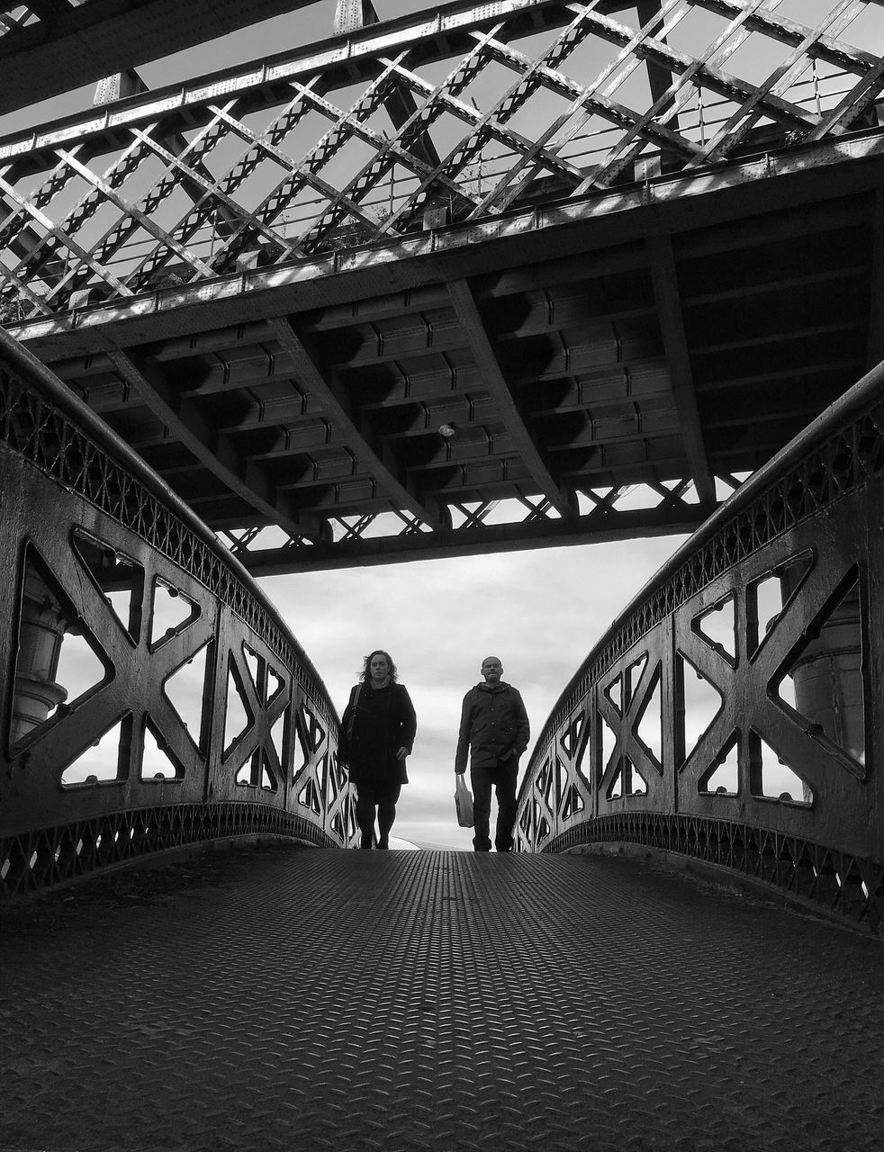 built structure, architecture, bridge - man made structure, lifestyles, walking, connection, men, leisure activity, full length, railing, rear view, the way forward, person, footbridge, silhouette, bridge, standing