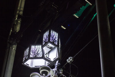 Low angle view of illuminated lights hanging on ceiling in building