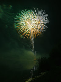 Low angle view of firework display at night