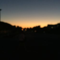 Defocused image of silhouette landscape against clear sky