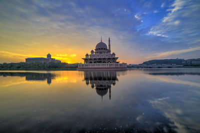 Reflection of temple in water at sunset