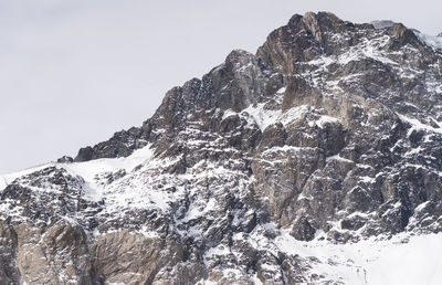 Low angle view of majestic mountains against clear sky