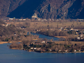 Scenic view of lake by city against mountain