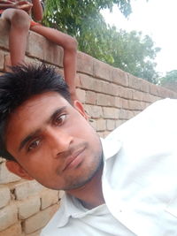 Portrait of young man against wall