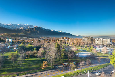 View of los dominicos park and neighborhood with los andes mountain range  in santiago de chile