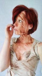 Close-up of messy woman against white background