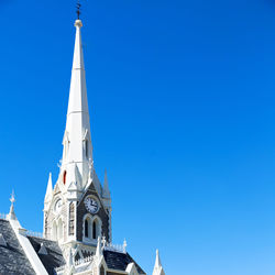 Low angle view of building against clear blue sky