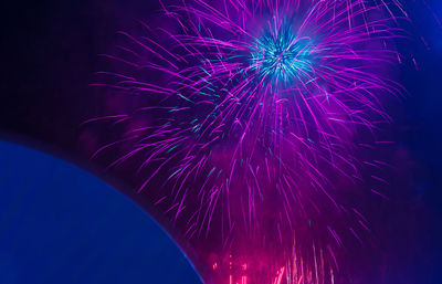 Low angle view of firework display at night