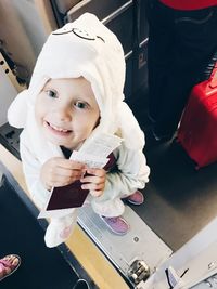 Portrait of a smiling girl holding camera