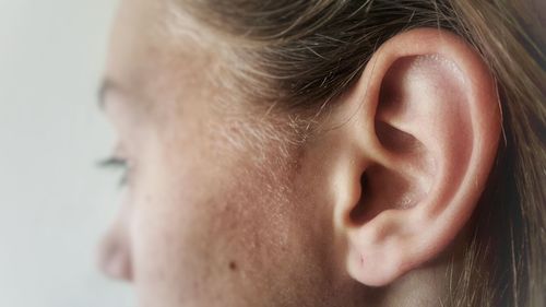Cropped image of teenage girl ear