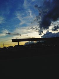 Silhouette car against sky during sunset