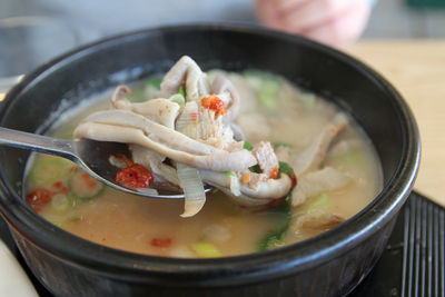 Korean pork rice soup or dwaeji-gukbap with the focus on pig stomach in a steaming stone bowl, busan