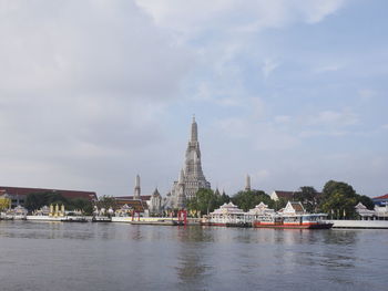 View of temple by building against sky