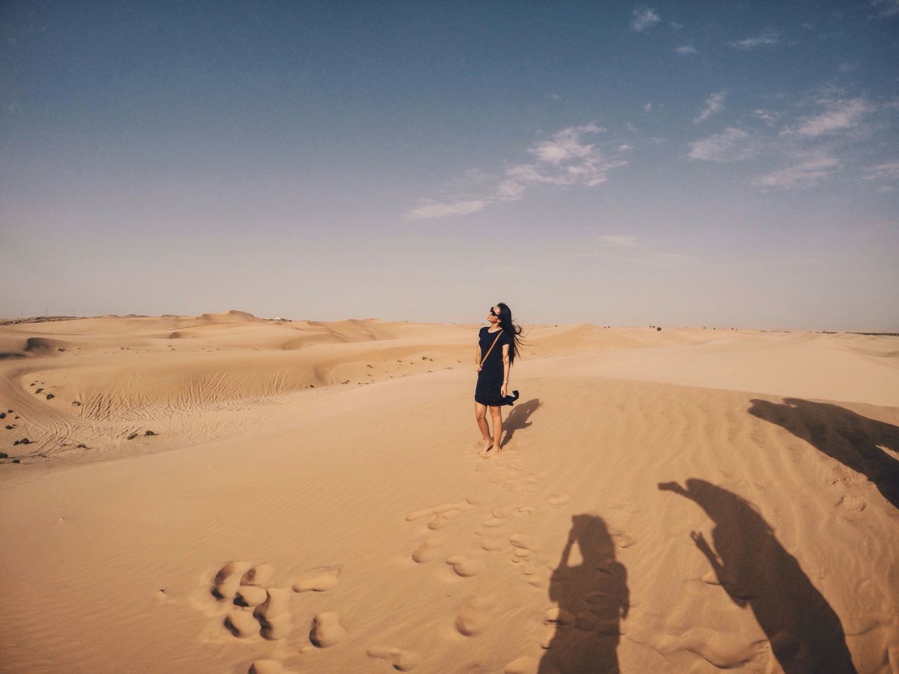 sand, full length, beach, lifestyles, leisure activity, sky, desert, casual clothing, men, rear view, vacations, landscape, sand dune, shore, tranquil scene, arid climate, tranquility, walking