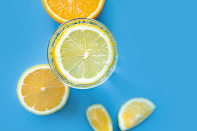 Close-up of lemon slice against blue background
