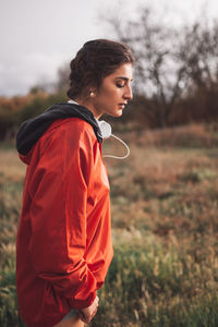 Side view of woman standing on field