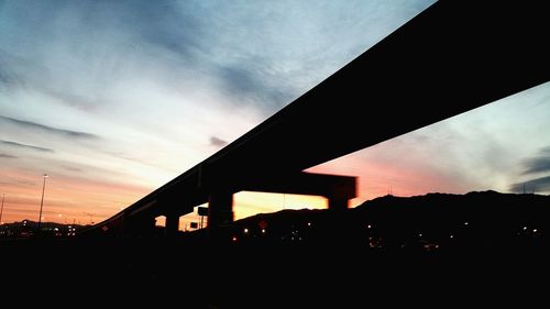 Silhouette bridge against sky during sunset