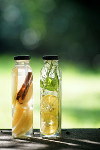 Close-up of fruit in jars of water