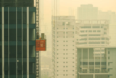 Detail of under construction high rise building in poor weather morning, haze of pollution