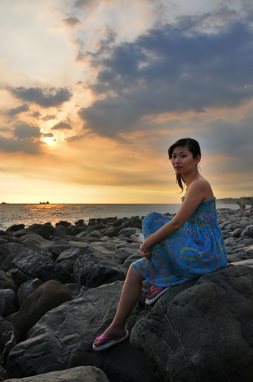 young adult, lifestyles, sky, person, sea, leisure activity, sunset, water, casual clothing, young women, horizon over water, full length, sitting, sunglasses, portrait, standing, beach, looking at camera