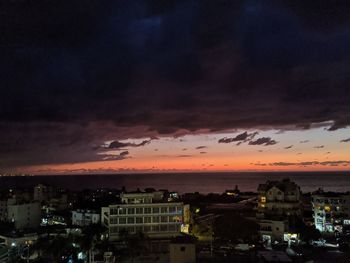 High angle view of illuminated buildings against sky during sunset