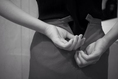 Mid section rear view of woman undressing