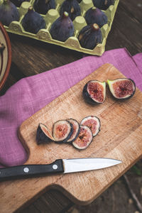 Top view of fresh cut figs on wooden board