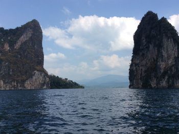 Scenic view of sea and mountains against sky