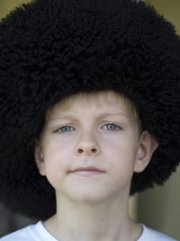 Close-up portrait of boy wearing uniform hat at event