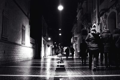 Illuminated street lights in city at night