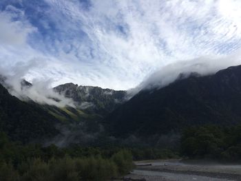 Clouds covering mountains against sky at hotaka