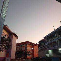 Low angle view of buildings against sky at dusk