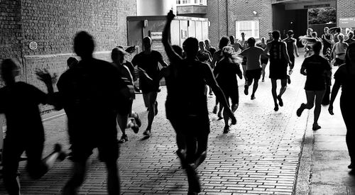 People running on street in city during marathon
