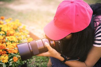 High angle view of woman photographing with camera