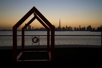 View of city at waterfront during sunset