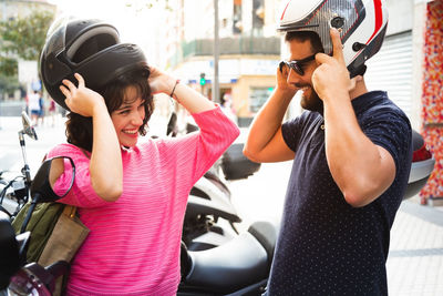 Midsection of woman holding camera while sitting in car