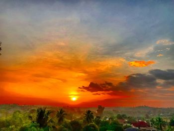 Scenic view of silhouette landscape against orange sky