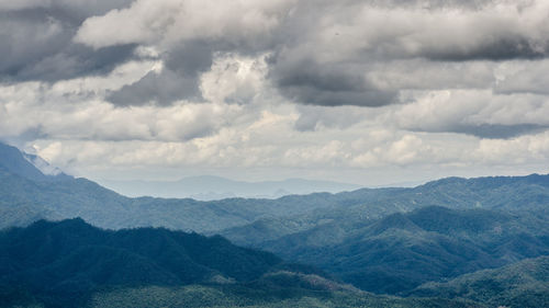 Scenic view of mountains against cloudy sky