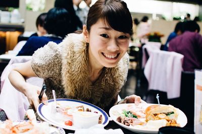 Portrait of young woman sitting in restaurant