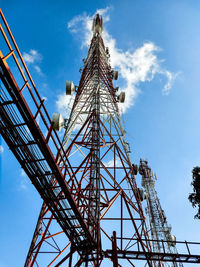 Low angle view of communications tower against sky