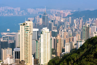 Aerial view of buildings in city against sky