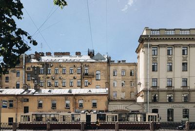 Low angle view of buildings in town against sky