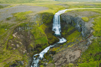 High angle view of waterfall amidst rocks