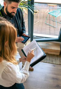 High angle view of business people having discussion in office