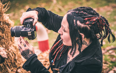 Close-up of mid adult woman photographing outdoors