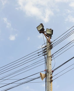 Low angle view of electricity pylon against sky