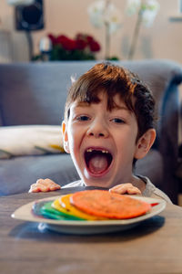 Portrait of boy with  pancakes in plate